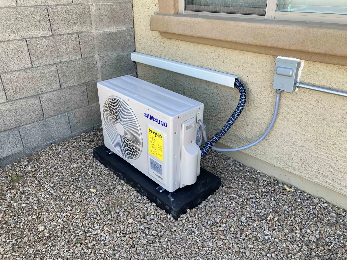 Samsung mini split outdoor unit on a pad with electrical disconnect